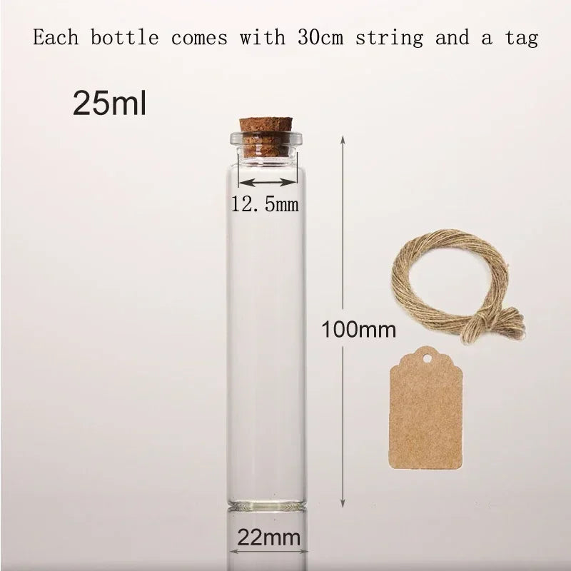 A clear glass bottle with a cork, measuring 22mm tall, next to a 30cm string and a tag.
