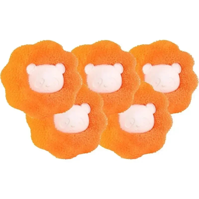 Three orange, fluffy balls shaped like heads with white faces for pet hair and lint removal