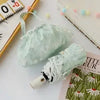 Light mint green full-automatic embroidered sun umbrella with a white handle and decorative fabric.