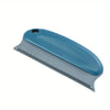 A blue pet hair remover brush with a silver blade and a handle, shown in profile.