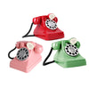 Two vintage-style retro phones in red and green plastic with silver dials and coiled cords.
