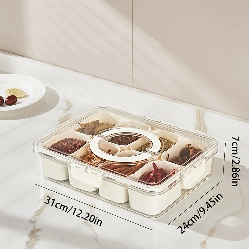 Clear plastic snack organizer tray with eight compartments holding various dried snacks on a white marble surface