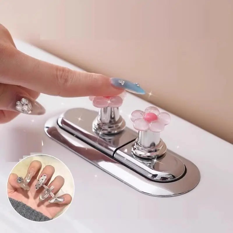 A hand presses a flower-shaped toilet flush button on a chrome flush plate.
