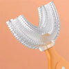 A clear silicone U-shaped toothbrush head attached to an orange handle.