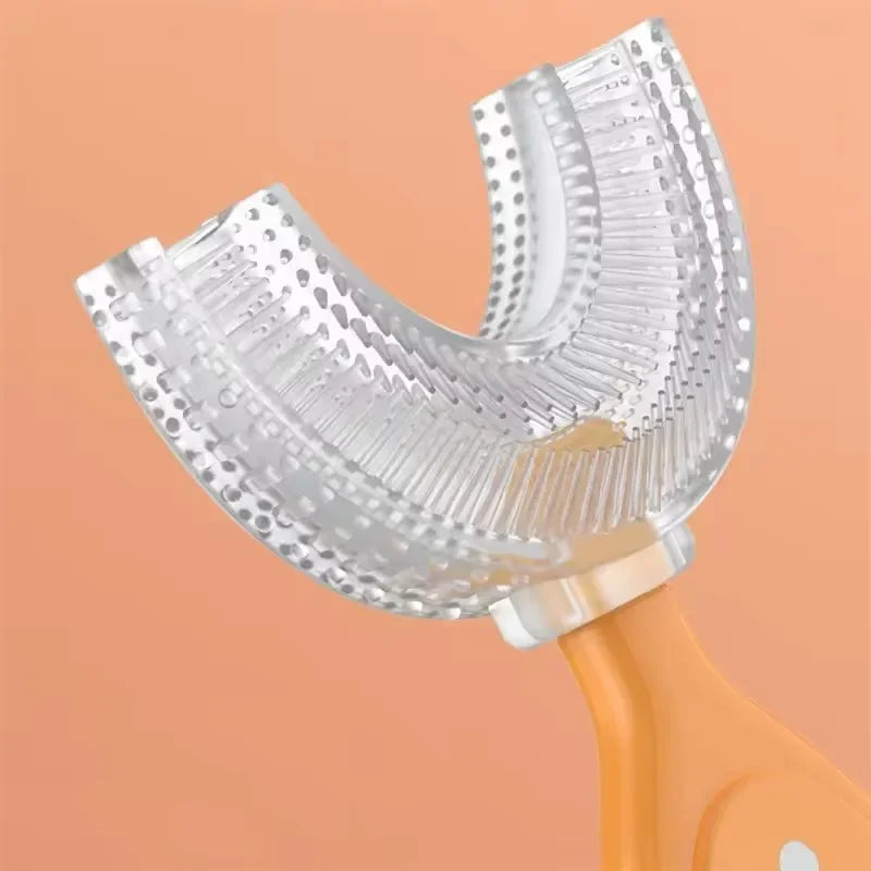 A clear silicone U-shaped toothbrush head attached to an orange handle.