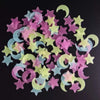 A collection of pink, yellow, and blue glow-in-the-dark 3D star and crescent moon wall decals.