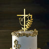 Gold acrylic cross cake topper featuring a dove and laurel leaves on a white cake.