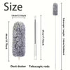 A gray electric dust duster with a telescopic rod shown next to its dimensions.