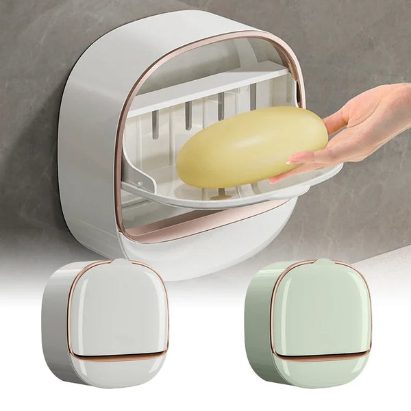A hand is placing a yellow soap dish into the opening of a white wall-mounted soap dish with a lid.