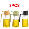 Three oil spray bottles in shades of yellow and green for cooking or storage.