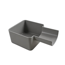 A gray laundry drain funnel and overflow protector with a square shape.