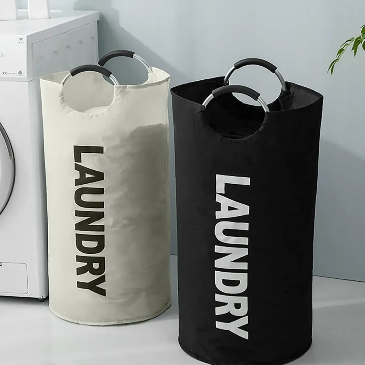 A white laundry basket and a black laundry basket standing side by side on a white surface.
