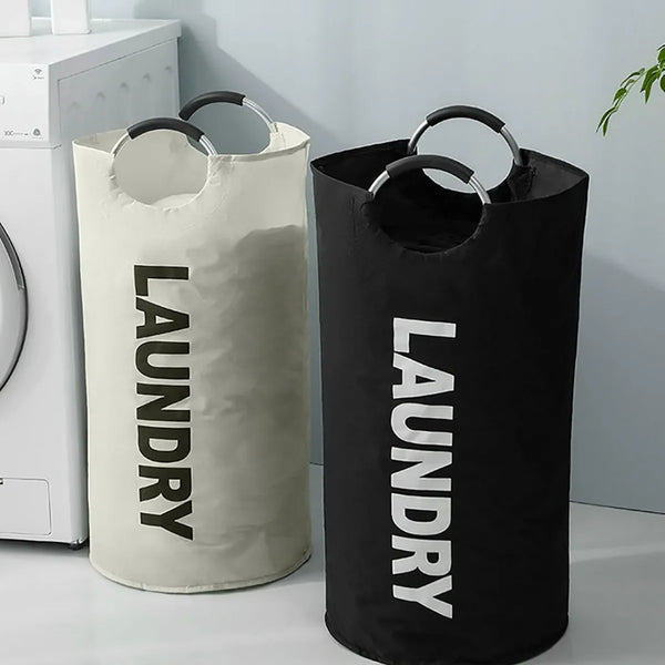 A white laundry basket and a black laundry basket standing side by side on a white surface.