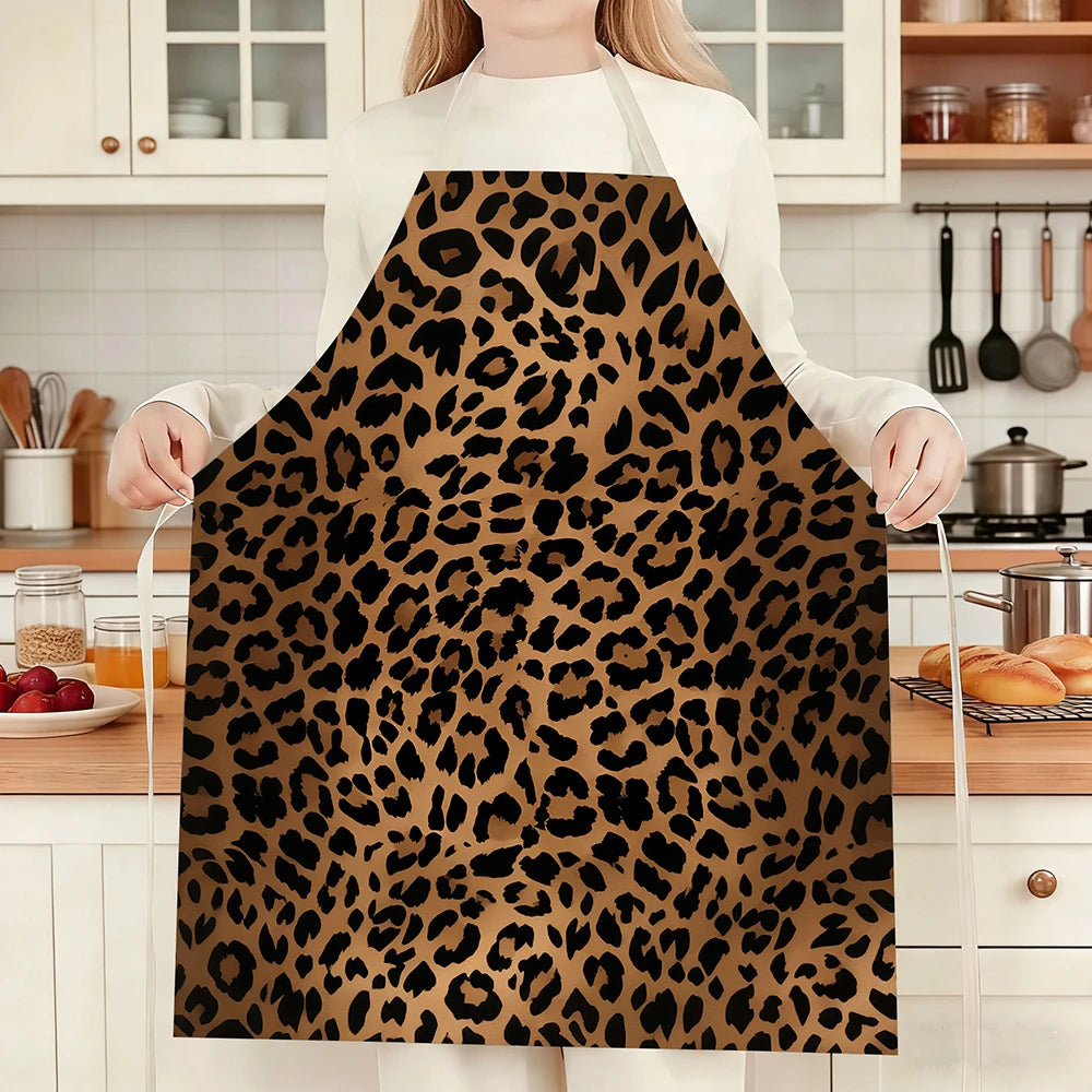 A person wearing a brown leopard print kitchen apron standing in a kitchen setting.