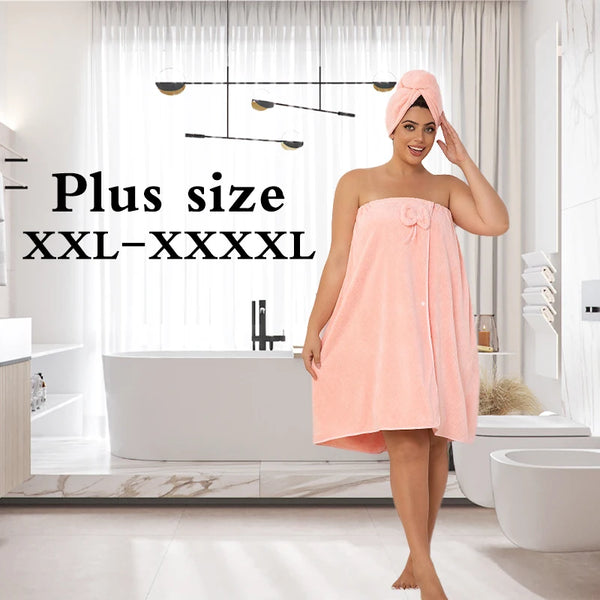 A woman wearing a peach-colored bath skirt and shower cap stands in a modern bathroom.
