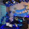 A decorated room with blue balloons and a banner spelling out Happy Birthday