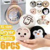 A set of six reusable wool dryer balls shaped like animals including a panda, pig, sheep, and others, shown next to a dryer.