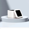 A stack of white reusable refill rings for kitchen trash cans displayed on a light gray surface.