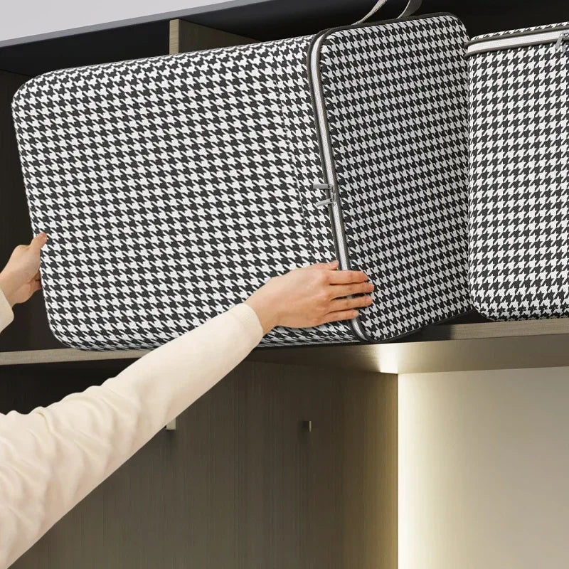 A hand is placing a quilted storage box with a clear window onto a shelf.