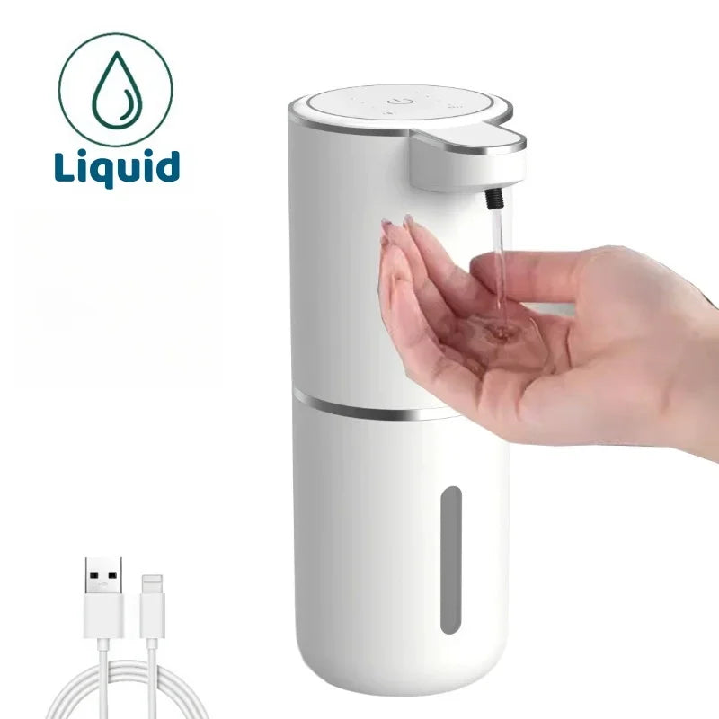 A white touchless electric soap dispenser is shown with a hand dispensing liquid soap.