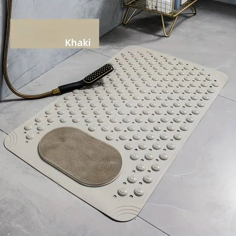 Alfombrilla de baño de masaje beige antideslizante con textura y asa sobre un suelo gris claro.