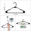 A black plastic clothes hanger with a digital scale measuring 6.6 lbs is shown.