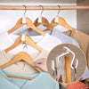 A close-up of a wooden clothes hanger with plastic hooks used for wardrobe organization.