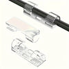 Clear adhesive cable clips used for organizing cables on desks and walls
