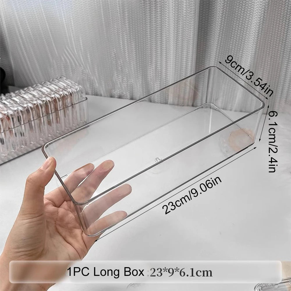 A hand holds a clear plastic jewelry organizer box with dimensions 23cm long by 9cm wide and 6.1cm deep.