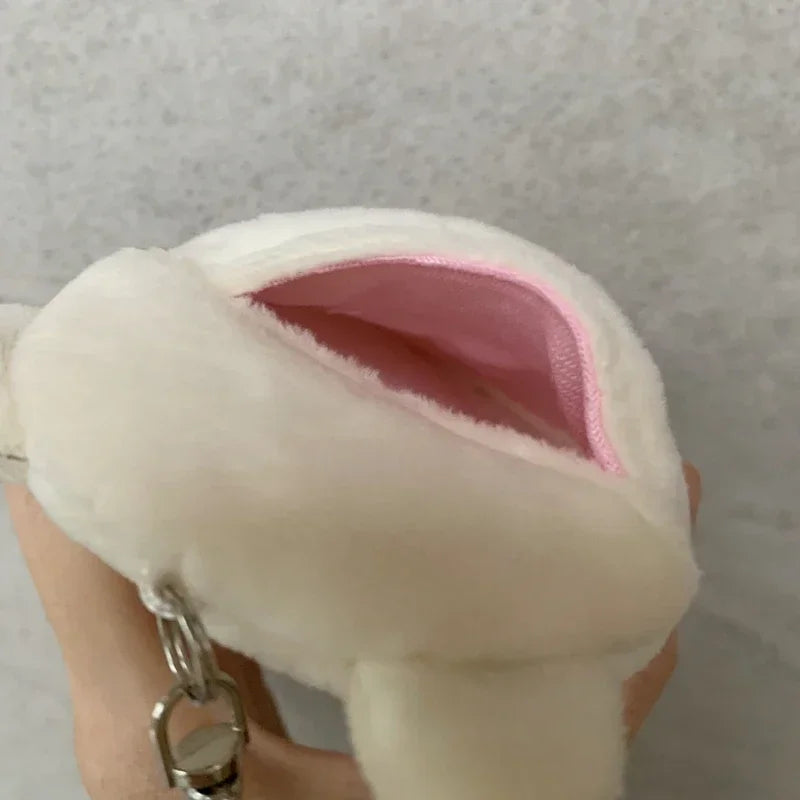 A white Rilakkuma plush ID card holder keychain is being held, showing the soft pink interior.