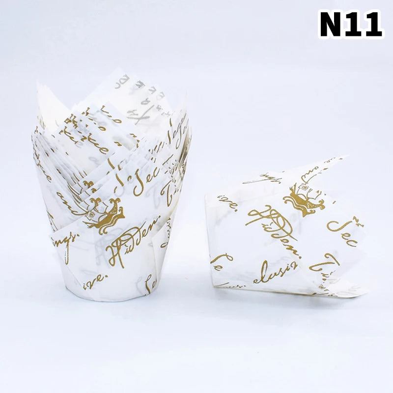 A stack of 50 tulip cupcake liners made of white paper with gold script writing.