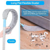 A long flat flexible duster with a handle is shown cleaning dust from the bottom gaps of furniture and appliances.