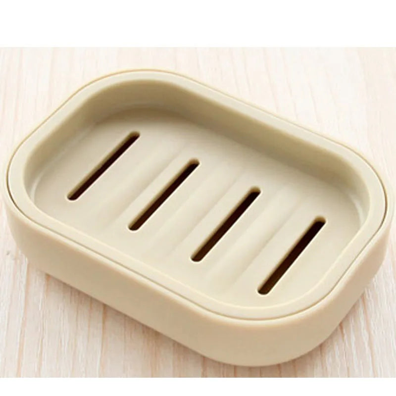 A beige double layer drain soap dish with three elongated slots for drainage.