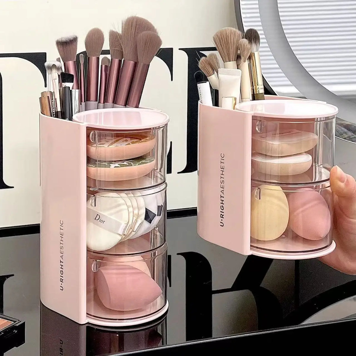 A pink acrylic rotating organizer for hair accessories and makeup brushes with various tools inside.