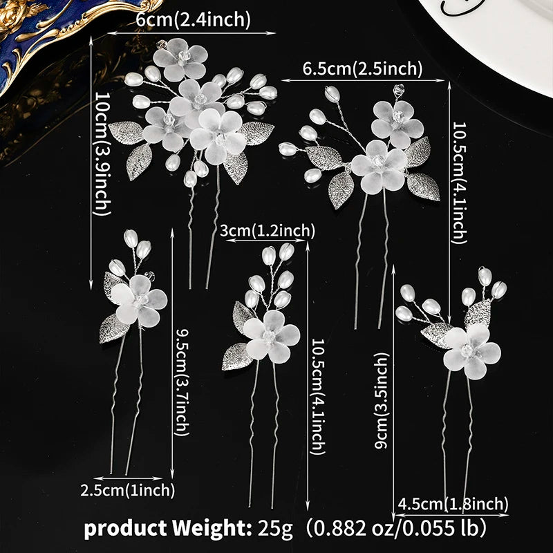 A set of white pearl flower bridal hair clips with varying lengths and sizes displayed against a black background.
