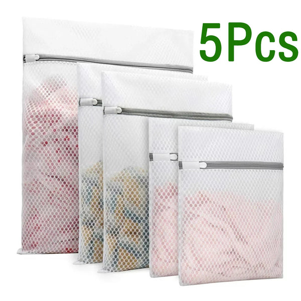 Five reusable mesh laundry bags in various sizes and colors stacked together