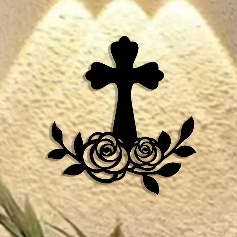 Black metal cross with a wreath of roses as wall art decor
