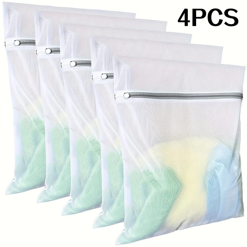 Four fine mesh laundry bags for delicate clothing in white and light green colors