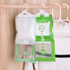 Green and white hanging bags for wardrobe use, containing moisture absorbers.