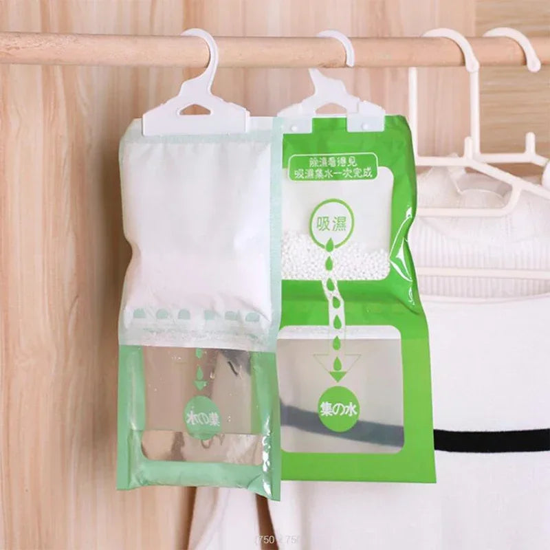 Green and white hanging bags for wardrobe use, containing moisture absorbers.