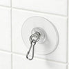A round, silver self-adhesive stainless steel wall hook is mounted on a white tiled surface.