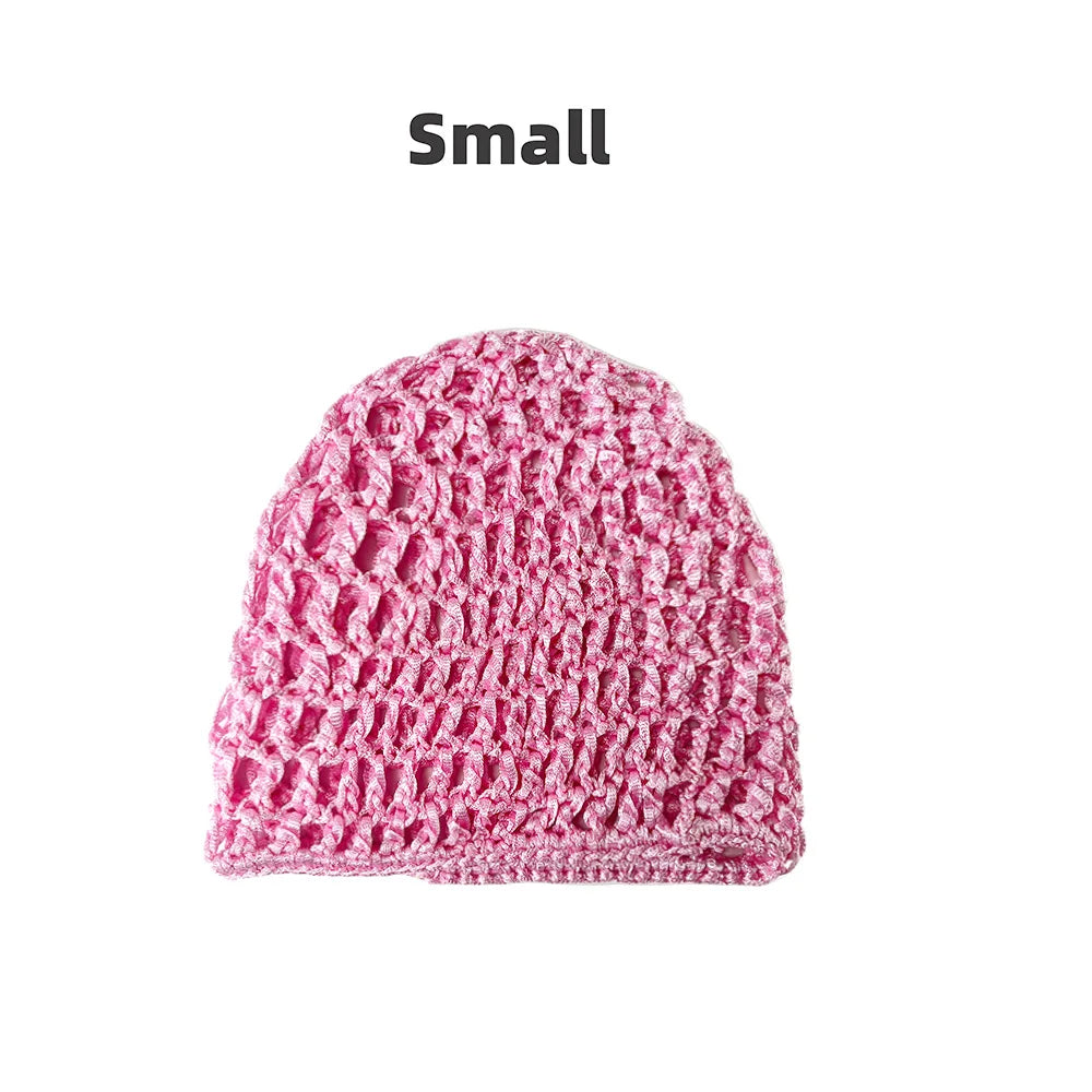 A small, pink, hand-crocheted mesh hair net cap.