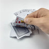 A hand is holding a King playing card from a deck of poker cards with other cards visible.