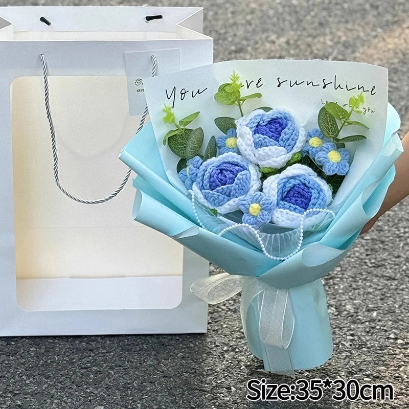 A handmade crochet flower bouquet featuring blue and yellow flowers with a handwritten message