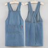 A light blue denim apron displayed on a hanger.