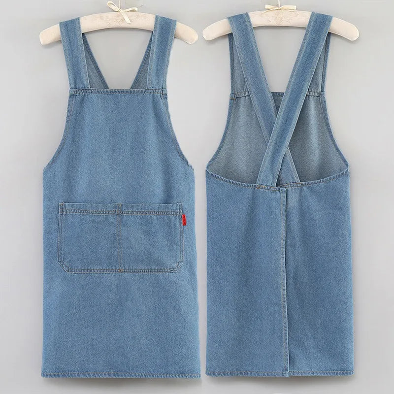 A light blue denim apron displayed on a hanger.
