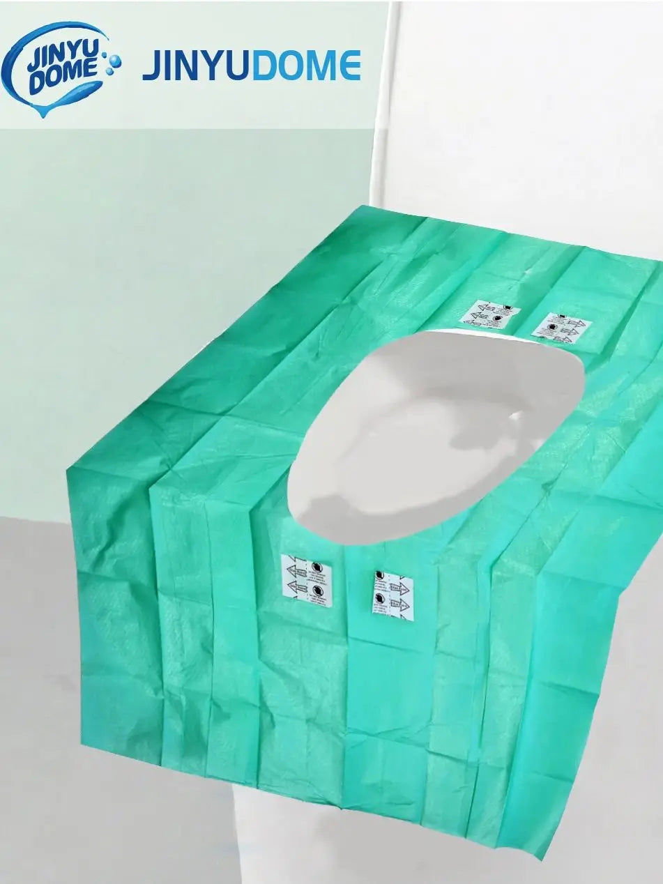 A green disposable waterproof toilet seat cover is shown in a packaged form.