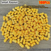 A pile of small peanut-shaped gold decorative ornaments, approximately 1cm long and 1.1g each.