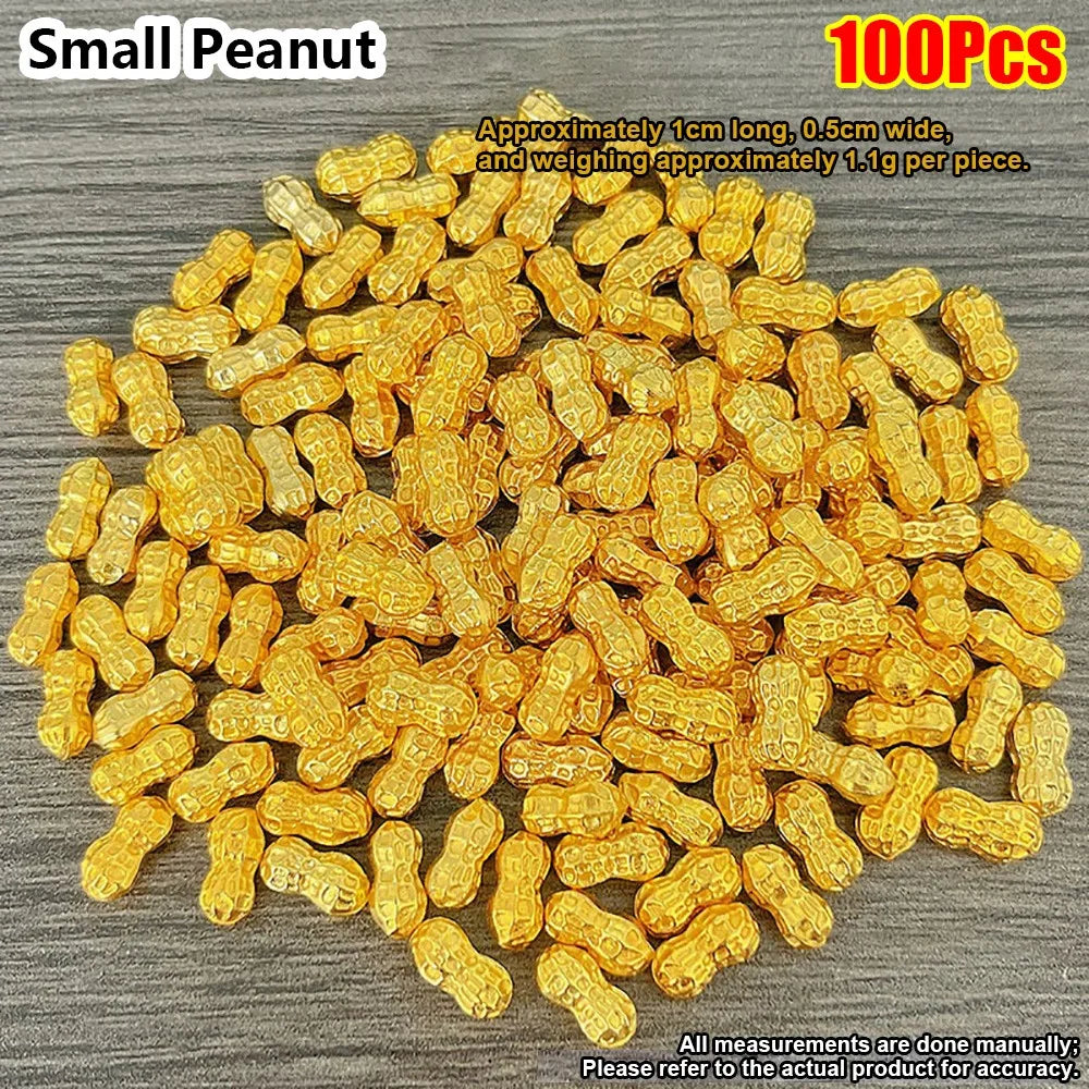 A pile of small peanut-shaped gold decorative ornaments, approximately 1cm long and 1.1g each.