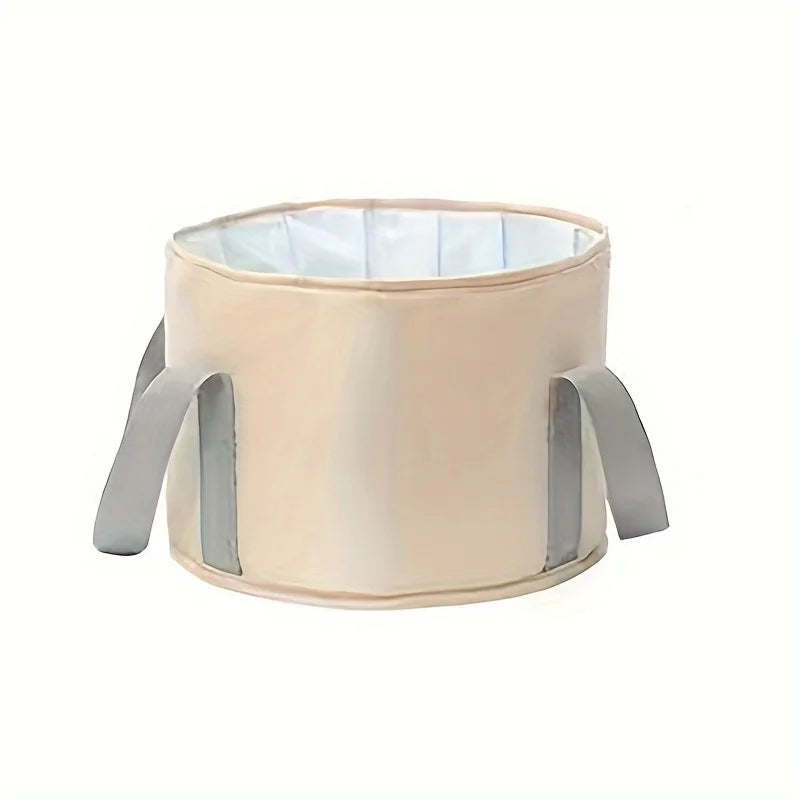 A beige portable folding foot soak tub with a light blue lining and gray handles.